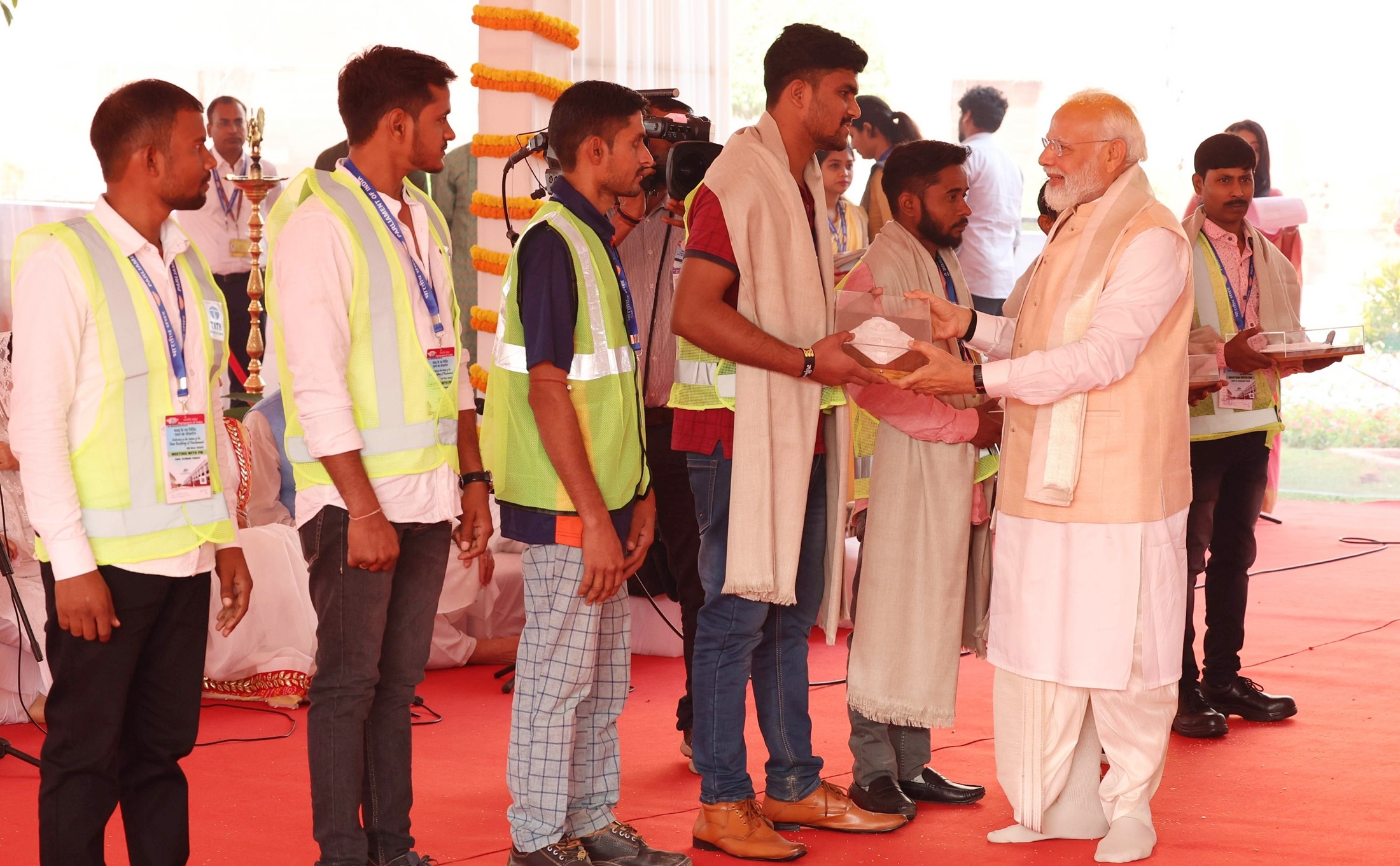 PM Modi felicitates workers who built the new Parliament building